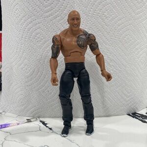 The rock WWE Action Figure with Black Pants and Brown Skin Tone